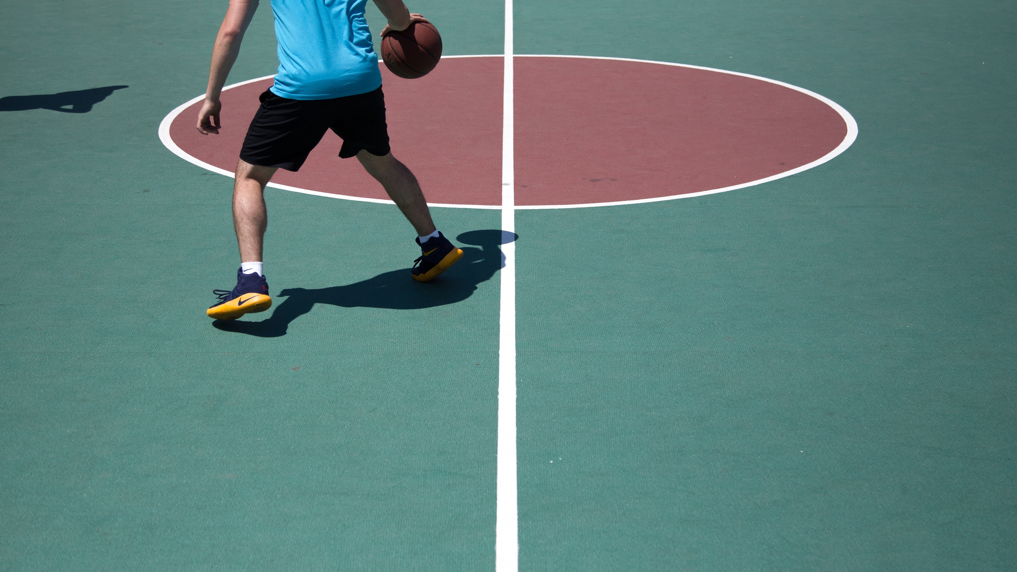 basketball player active on court. Basketball players may experience tendinopathy