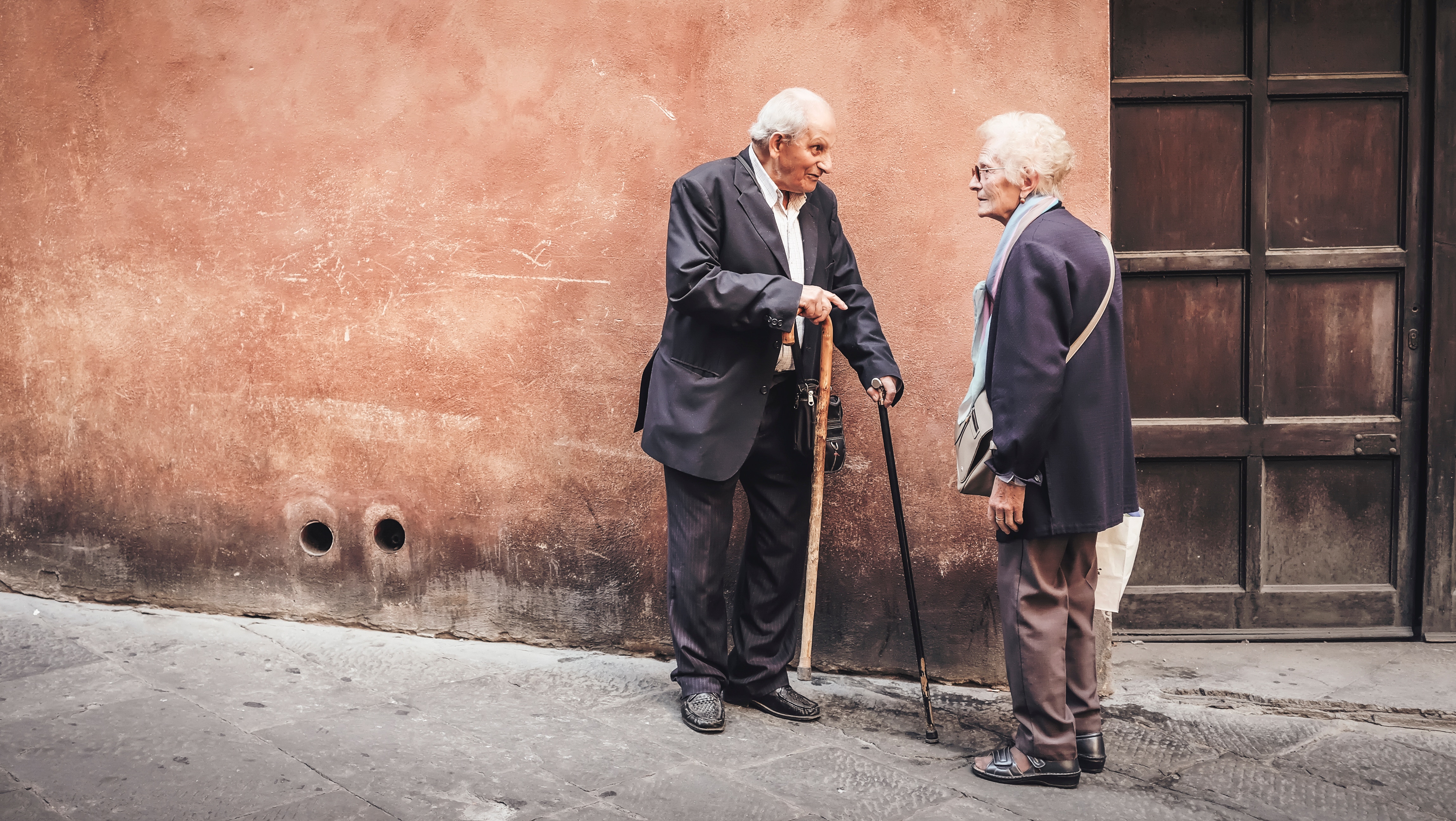 old couple talking in the street